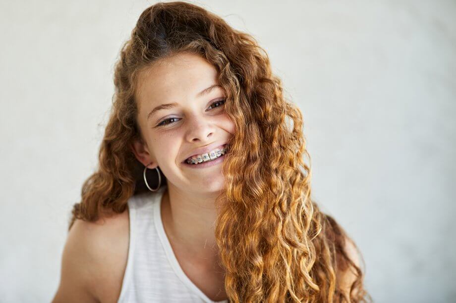 a smiling adolescent with braces