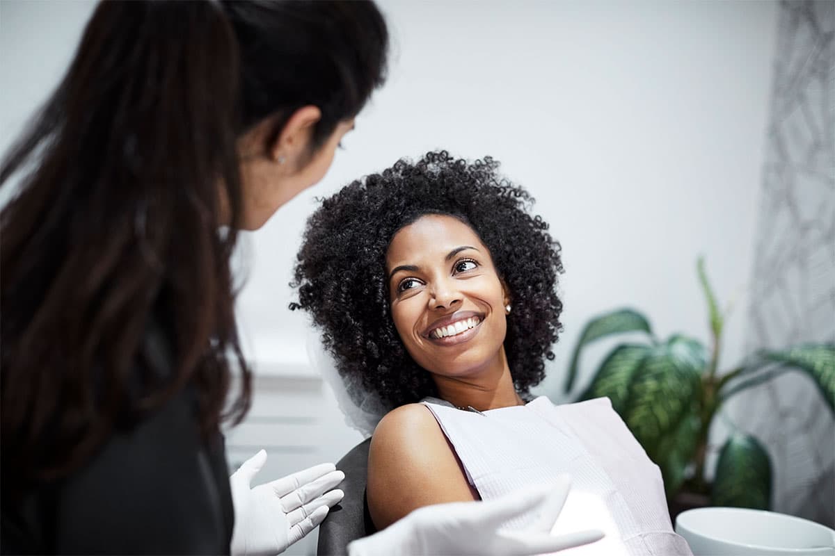 Lady in chair smiling at assistant image